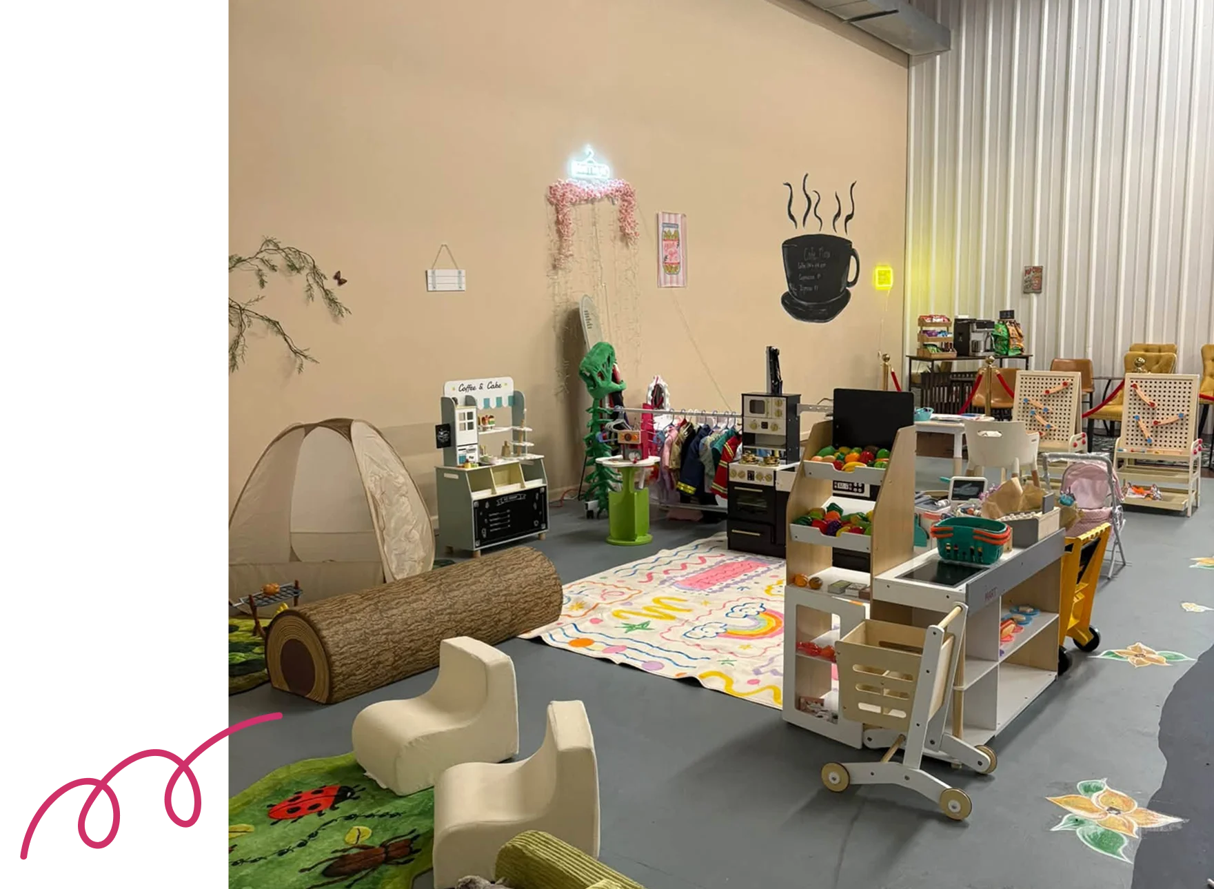 Room filled with lots of toys and furniture, including chairs, tables, carpets, and other objects